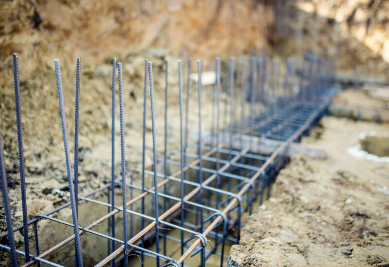 Foundation site of new building, details and reinforcements with steel bars and wire rod, preparing for cement pouring